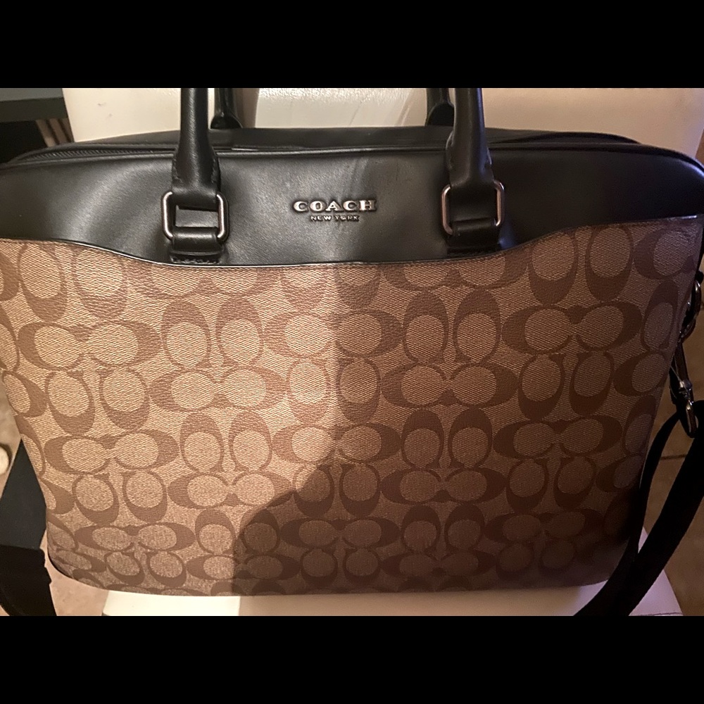 Coach travel brief case can fit books laptops has a longer strap very